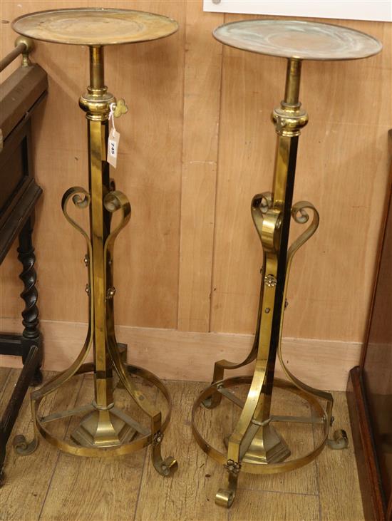A pair of telescopic brass stands Width of base 38cm